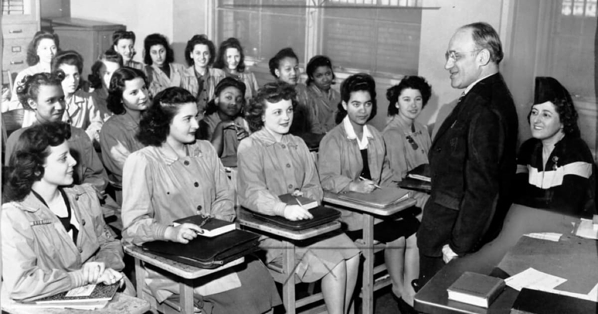 Principal Mortimer C. Ritter addresses an academic class at the Needle Trades High School, New York, in April 6, 1944. Students include Fergel Levine, Jean Cultrera, and Ellen Perino., featured image for Brand authority signals for education and institutions in Paraguay
