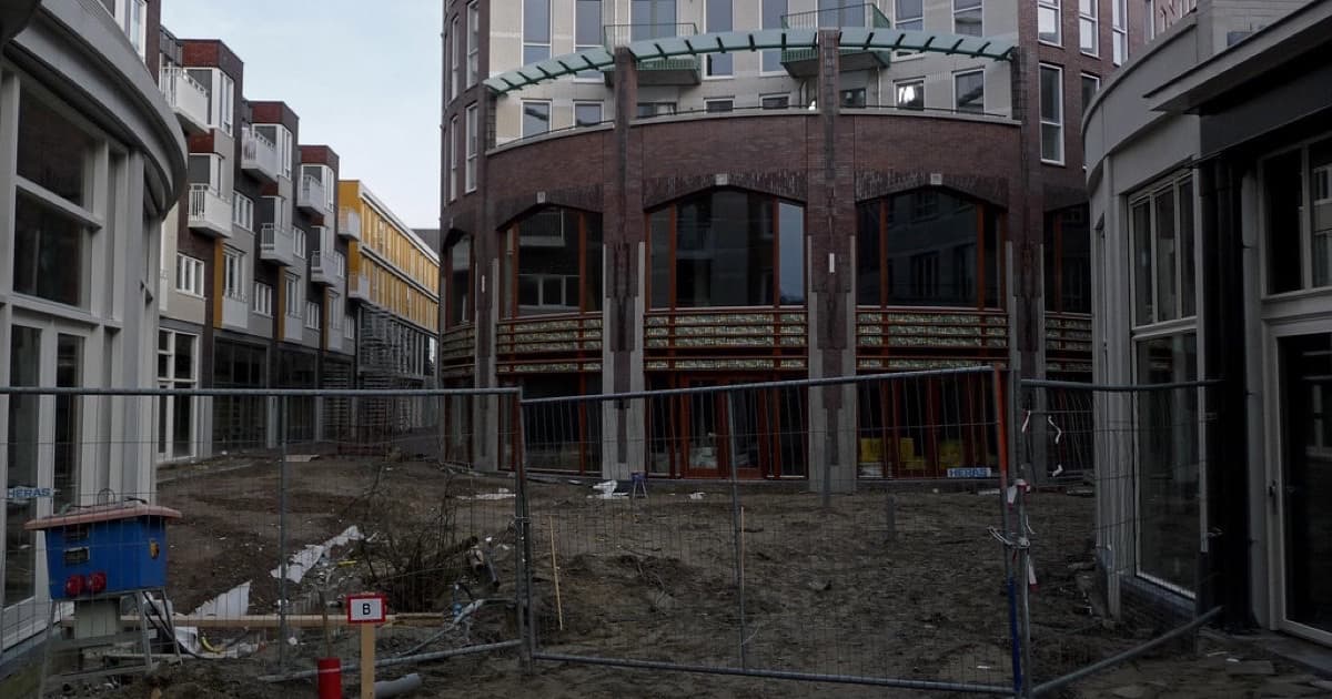 2014.01 - Amsterdam in photo: Modern architecture and sandy pavement, still behind the fence; Oosterpoort; a geotagged free urban picture, in public domain / Commons CCO; city photography by Fons Heijnsbroek, The Netherlands, featured image for Technical SEO foundations before GEO for real estate and construction